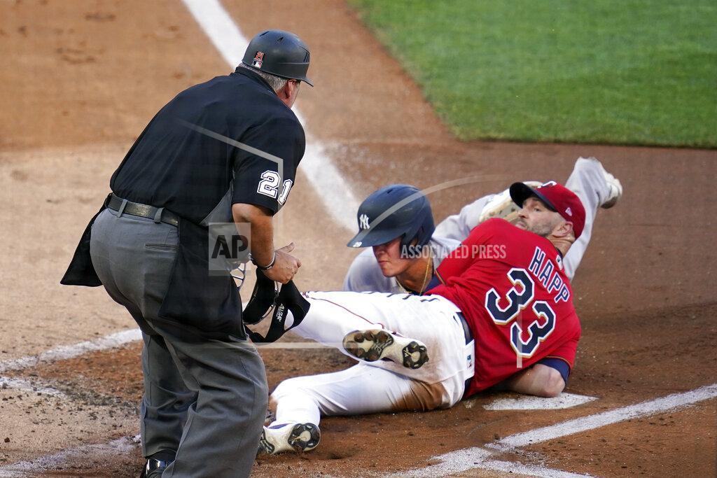 Jim Mone Minnesota Twins pitcher J.A. Happ (33) looks for the call by umpire Hunter Wendelstedt after tagging New York Yankees' Gio Urshela at the plate during the first inning of a baseball game Thursday, June 10, 2021, in Minneapolis. Urshela was initially called safe but on review the call was changed. (AP Photo/Jim Mone)