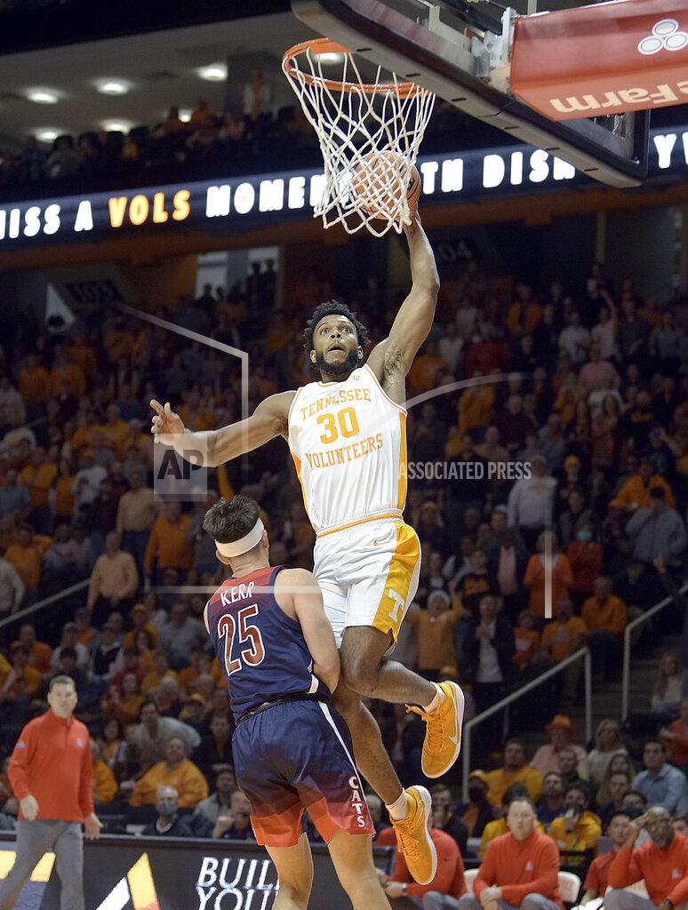 Scott Keller Tennessee's Josiah-Jordan James (30) dunks over Arizona's Kerr Kriisa (25) during the first half of an NCAA college basketball game Wednesday, Dec. 22, 2021, in Knoxville, Tenn. (Scott Keller/The Daily Times via AP)