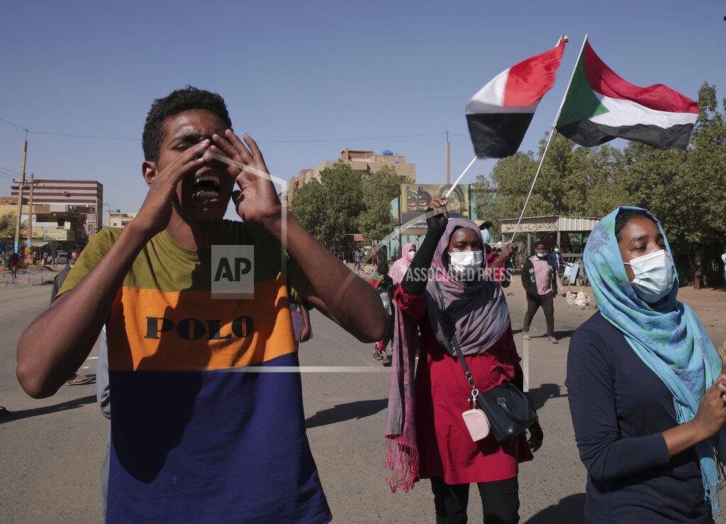 Marwan Ali Protesters take to the streets to renew their demand for a civilian government in the Sudanese capital Khartoum, Thursday, Nov. 25, 2021. The rallies came just days after the military signed a power-sharing deal with the prime minister, after releasing him from house arrest and reinstating him as head of government. The deal came almost a month after the generals orchestrated a coup. Sudan’s key pro-democracy groups and political parties have dismissed the deal as falling short of their demands for a fully civilian rule. (AP Photo/Marwan Ali)