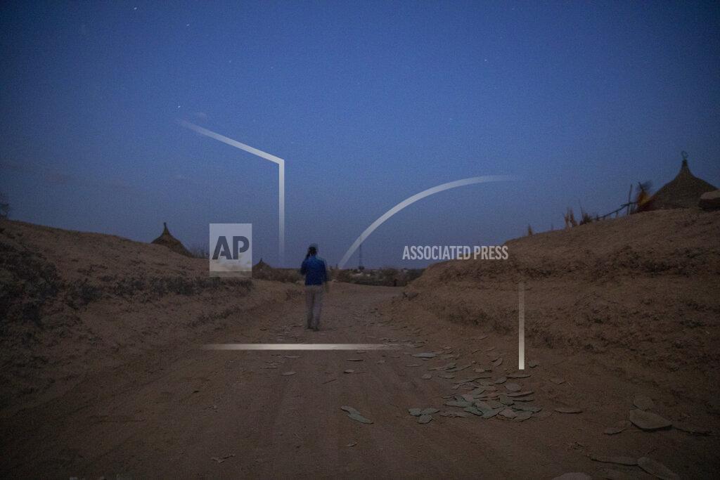 Nariman El-Mofty Surgeon and doctor-turned-refugee, Dr. Tewodros Tefera, makes his way to the clinic run by MSF (Doctors Without Borders), in Hamdayet, eastern Sudan, near the border with Ethiopia, on March 22, 2021. He used to write down reflections so emotional on the war and his new life that he later burned them. “Ethiopia is dead to me,” he says, then corrects himself: “Ethiopia is dying.” (AP Photo/Nariman El-Mofty)