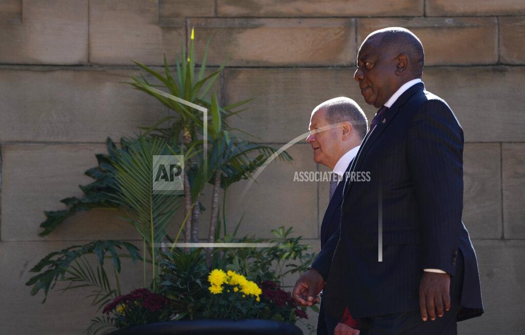 Themba Hadebe German Chancellor Olaf Scholz, left, walks with South Africa President Cyril Ramaphosa after the official welcoming ceremony at the Union Building in Pretoria, South Africa, Tuesday, May 24, 2022. (AP Photo/Themba Hadebe)