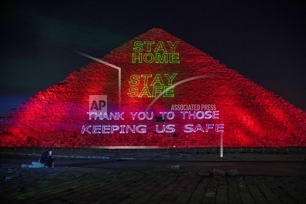 Nariman El-Mofty FILE - In this March 30, 2020 file photo, the Ministry of Antiquities lights up the pyramids of Giza in an expression of support for health workers battling the coronavirus outbreak, in Giza, Egypt. The confirmed death toll from the coronavirus has gone over 50,000 in the Middle East as the pandemic continues. That’s according to a count Thursday, Sept. 3, 2020, from The Associated Press, based on official numbers offered by health authorities across the region. (AP Photo/Nariman El-Mofty, File)