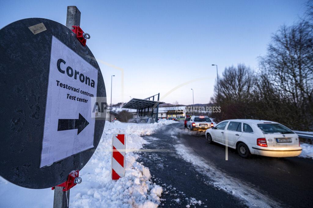 Armin Weigel Cars queue in front of a Corona test station at the German-Czech Republic border in Furth im Wald, Germany, Monday, Jan. 25, 2021. German police say hundreds of cars and pedestrians are lining up at border crossings along the Czech-German border after Germany declared the Czech Republic a high risk area in the pandemic meaning it requires proof a negative coronavirus test results before entry. (Armin Weigel/dpa via AP)