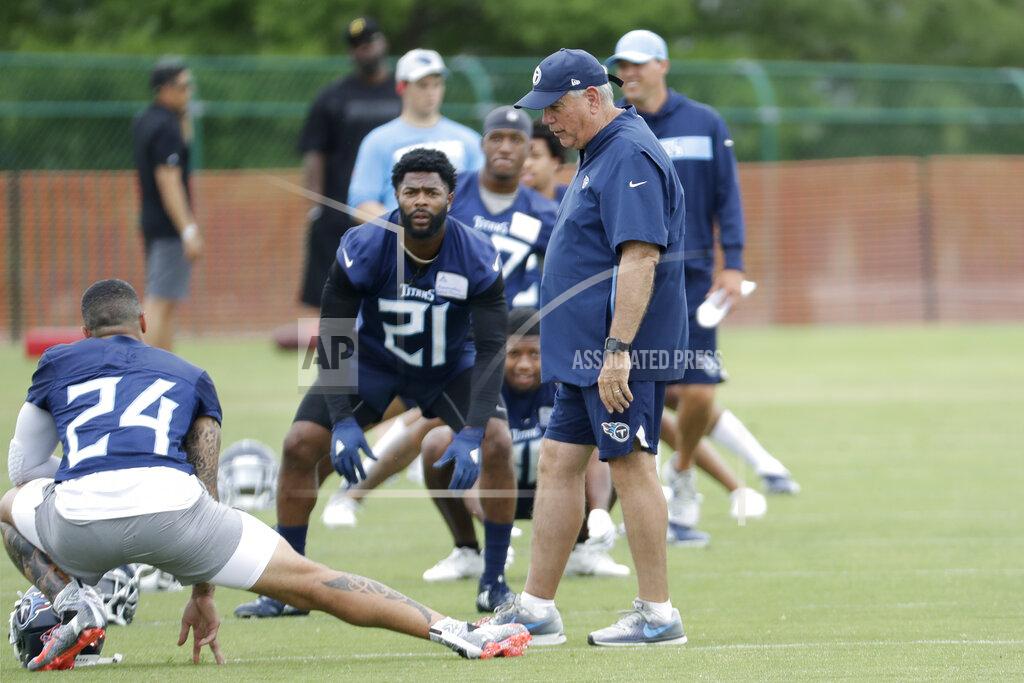 Mark Humphrey Tennessee Titans defensive coordinator Dean Pees, front right, talks with safety Kenny Vaccaro (24) and cornerback Malcolm Buter (21) during an organized team activity at the Titans' NFL football training facility Tuesday, June 4, 2019, in Nashville, Tenn. Pees wants more than the 39 sacks the Titans managed in 2018, putting them in a tie for 16th in the NFL. Pees has made it clear he's only worried about making sure the Titans do what's asked of them on defense. (AP Photo/Mark Humphrey)
