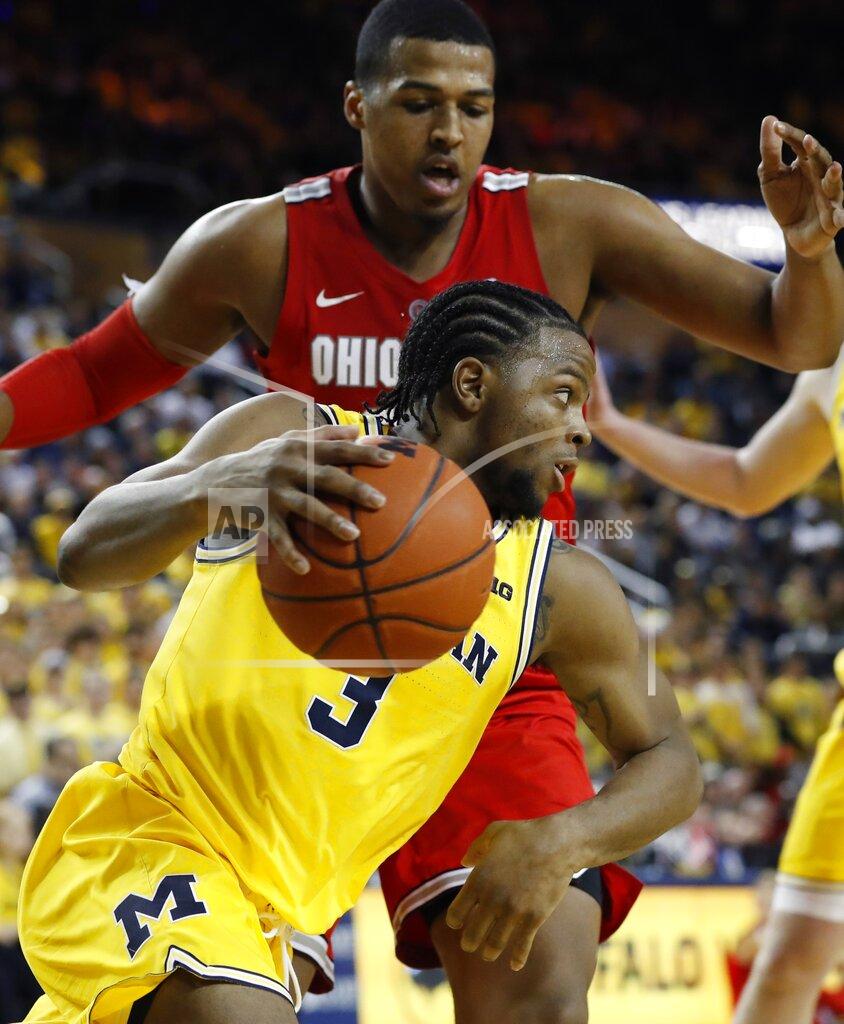 Carlos Osorio Michigan guard Zavier Simpson (3) drives around Ohio State forward Kaleb Wesson during the second half of an NCAA college basketball game Tuesday, Jan. 29, 2019, in Ann Arbor, Mich. (AP Photo/Carlos Osorio)