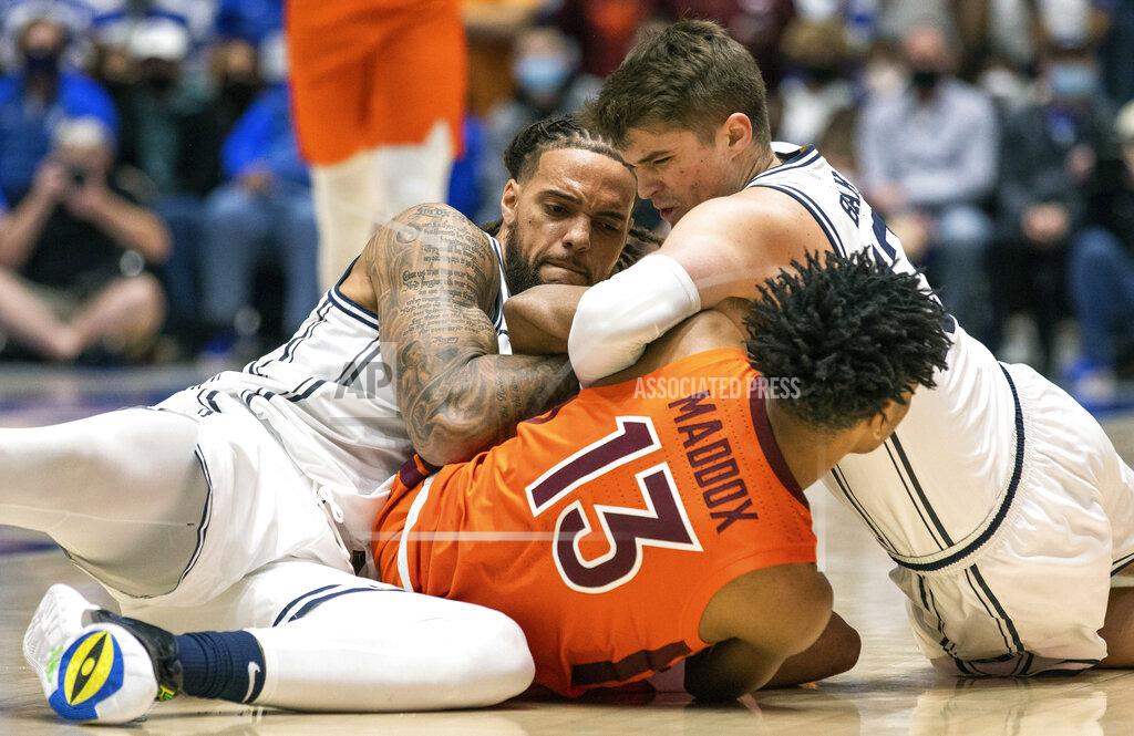Ben Mckeown Virginia Tech's Darius Maddox (13) battles Duke's Theo John, left, and Duke's Joey Baker, right, for a loose ball during the first half of an NCAA college basketball game in Durham, N.C., Wednesday, Dec. 22, 2021. (AP Photo/Ben McKeown)
