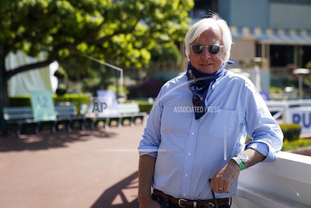 Ashley Landis In this Friday, May 22, 2020 photo, Bob Baffert, two-time Triple Crown-winning trainer, lowers his bandana during an interview while keeping his distance at Santa Anita Park in Arcadia, Calif. Horse racing returned to the track after being idled for one and a half months because of public health officials' concerns about the coronavirus pandemic. (AP Photo/Ashley Landis)