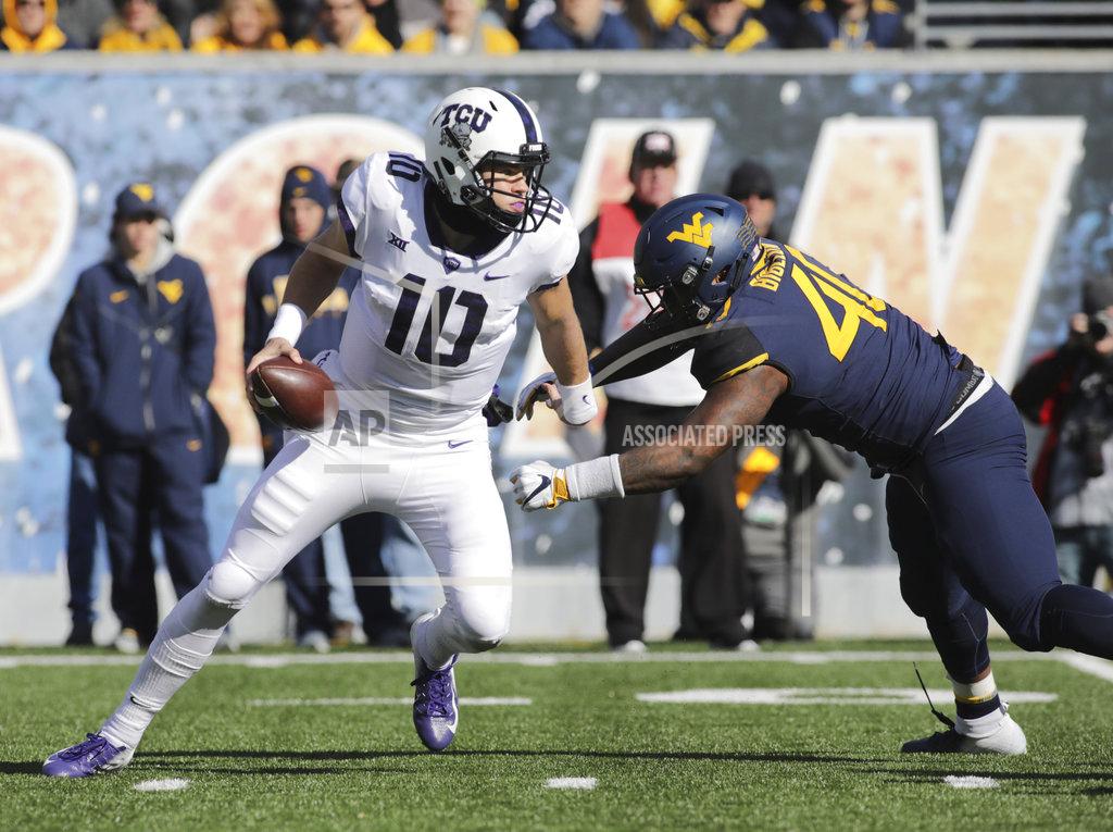 Ray Thompson TCU quarterback Michael Collins (10) is nearly sacked by West Virginia defensive lineman Kenny Bigelow Jr. (40) during the first half of an NCAA college football game Saturday, Nov. 10, 2018, in Morgantown, W.Va. (AP Photo/Raymond Thompson)