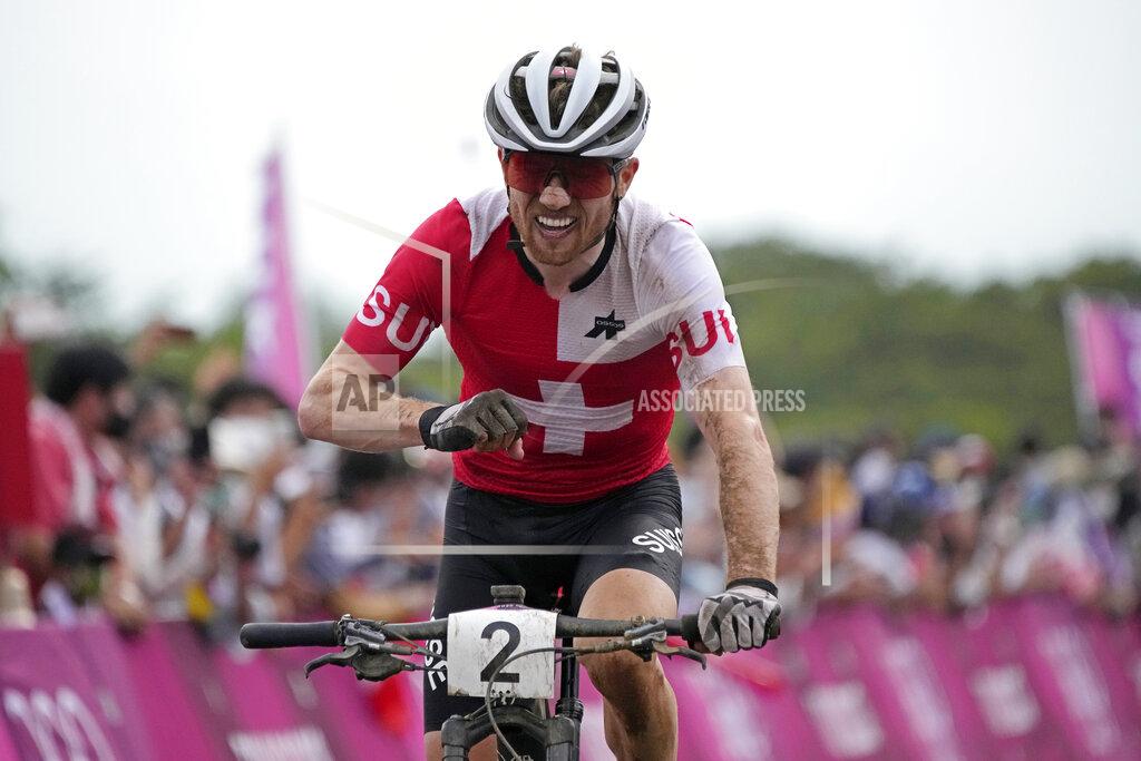 Christophe Ena FILE - Mathias Flueckiger of Switzerland reacts as he crosses the finish line to win the silver medal during the men's cross country mountain bike competition at the 2020 Summer Olympics, Monday, July 26, 2021, in Izu, Japan. Olympic silver medalist Mathias Flückiger was provisionally suspended in a doping case ahead of his scheduled competition Friday, Aug. 19, 2022 in mountain bike cross country at the European Championships. (AP Photo/Christophe Ena, File)