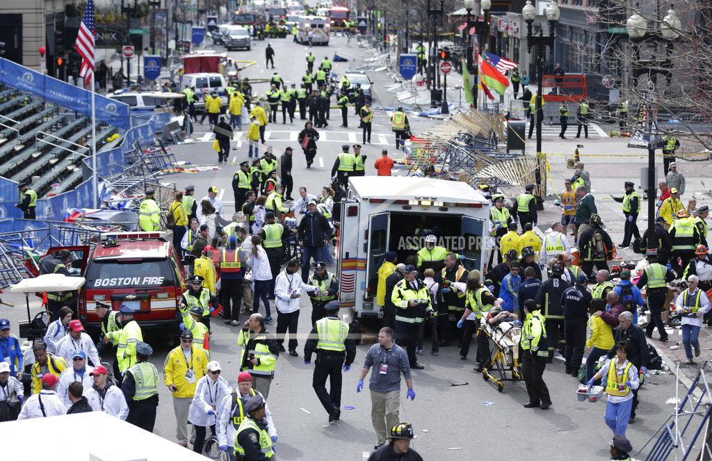 FILE - In this April 15, 2013, file photo, medical workers aid injured people at the finish line of the 2013 Boston Marathon following an explosion in Boston. (AP Photo/Charles Krupa, File)