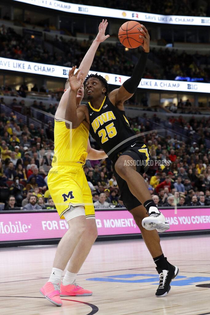 Nam Y. Huh Iowa's Tyler Cook (25) goes up for a basket against Michigan's Jon Teske during the first half of an NCAA college basketball game in the quarterfinals of the Big Ten Conference tournament, Friday, March 15, 2019, in Chicago. (AP Photo/Nam Y. Huh)