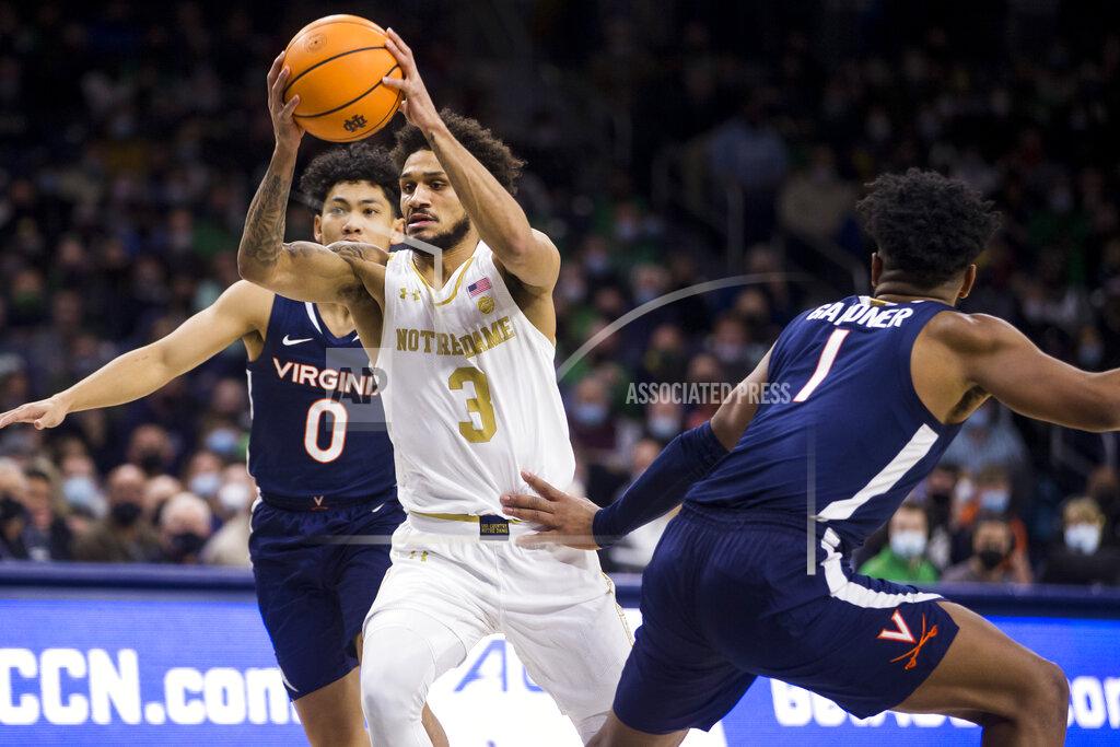 Robert Franklin Notre Dame's Prentiss Hubb (3) drives between Virginia's Kihei Clark (0) and Jayden Gardner (1) during the second half of an NCAA college basketball game Saturday, Jan. 29, 2022, in South Bend, Ind. (AP Photo/Robert Franklin)