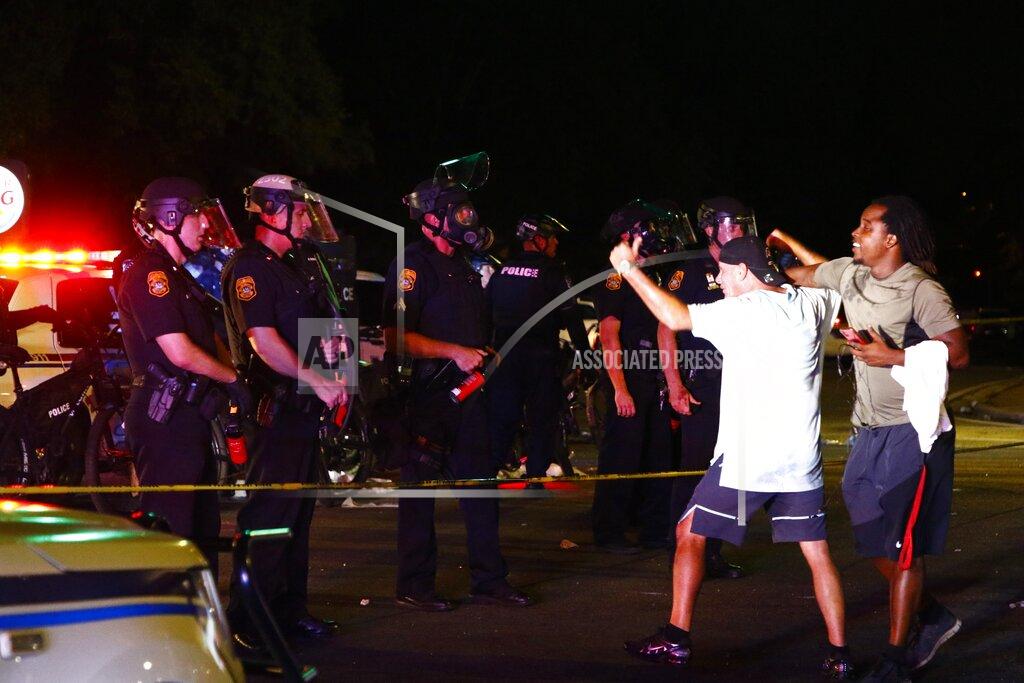 Luis Santana A protester taunts police officers on Busch blvd in Tampaa, on Saturday, May 30, 2020. Protests were held throughout the country over the death of George Floyd, a black man who died after being restrained by Minneapolis police officers on May 25. (Luis Santana/Tampa Bay Times via AP)