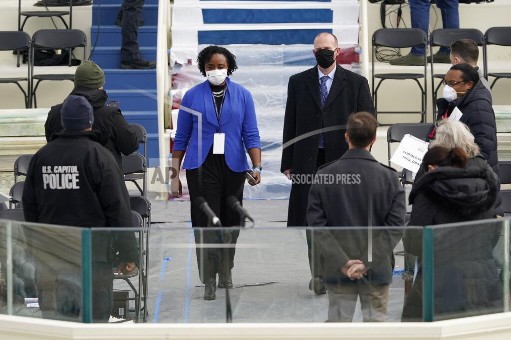 Patrick Semansky Stand-ins for Vice President-elect Kamala Harris, left, and Doug Emhoff, walk on to the podium during a rehearsal for the 59th Presidential Inauguration at the U.S. Capitol in Washington, Monday, Jan. 18, 2021. (AP Photo/Patrick Semansky, Pool)