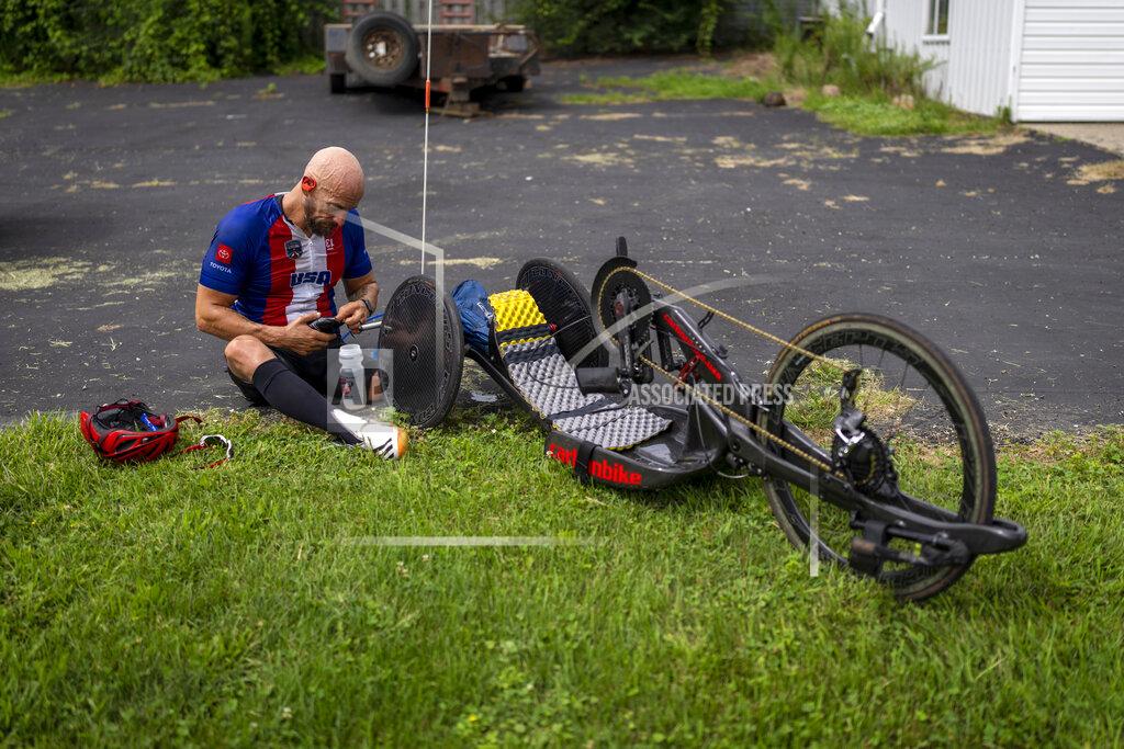 Emilio Morenatti Tom Davis takes a break during his riding session as part of his daily training in Fremont, Ind., Tuesday, Aug. 17, 2021. Twenty years after the attacks of Sept. 11, and just days after the Taliban took control of Kabul, Davis is one of the small group of American combat veterans competing in the Tokyo Paralympics -- a corps of elite athletes who have triumphed over catastrophic injuries they suffered in Iraq and Afghanistan. (AP Photo/Emilio Morenatti)