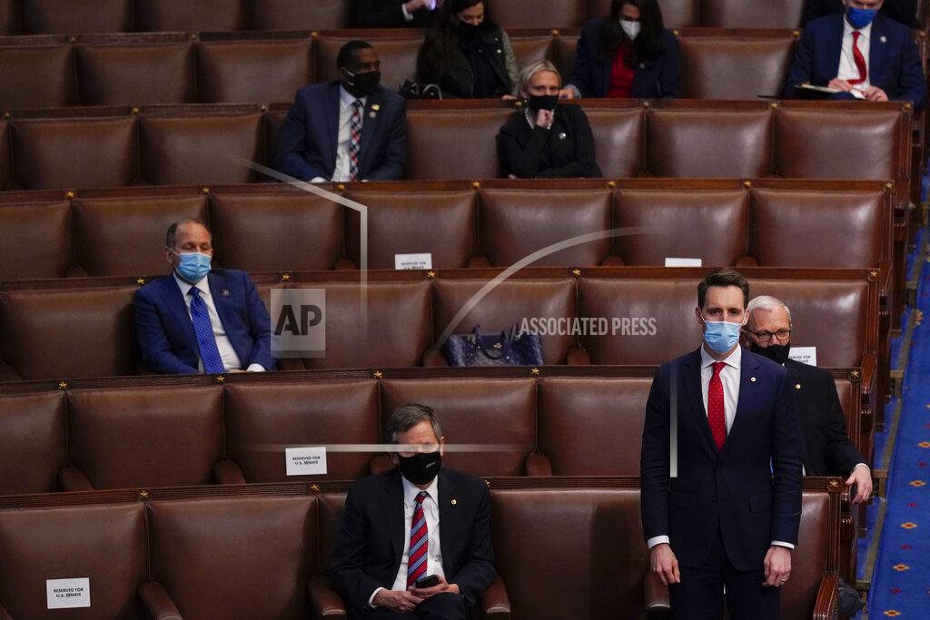 Andrew Harnik Sen. Josh Hawley, R-Mo., rises to join House Republican members to object to confirming the Electoral College votes from Pennsylvania during a joint session of the House and Senate to confirm the Electoral College votes cast in November's election, at the Capitol, early Thursday, Jan 7, 2021, in Washington. (AP Photo/Andrew Harnik)