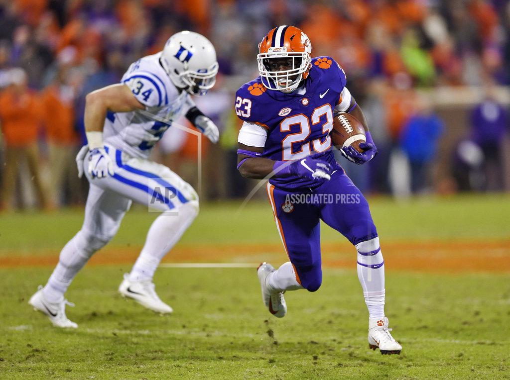 Richard Shiro Clemson's Lyn-J Dixon rushes while defended by Duke's Ben Humphreys during the second half of an NCAA college football game Saturday, Nov. 17, 2018, in Clemson, S.C. (AP Photo/Richard Shiro)