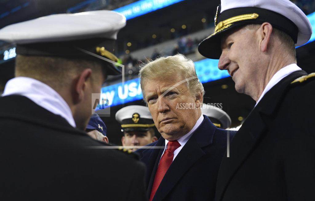 Susan Walsh President Donald Trump, center, standing with Naval Academy Superintendent Vice Adm. Ted Carter, right, talks with people during the second half of the Army-Navy football game in Philadelphia, Saturday, Dec. 8, 2018. (AP Photo/Susan Walsh)