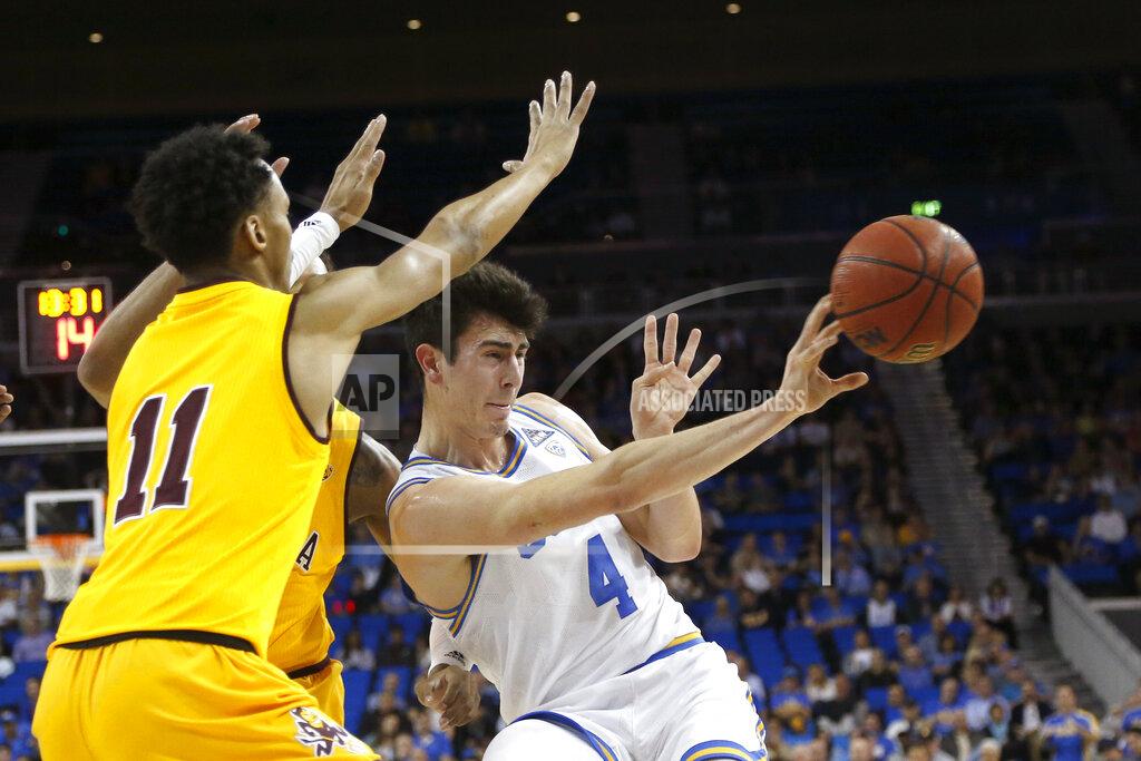 Ringo H.w. Chiu UCLA guard Jaime Jaquez Jr. (4) passes the ball while defended by Arizona State players, including guard Alonzo Verge (11), during the first half of an NCAA college basketball game Thursday, Feb. 27, 2020, in Los Angeles. (AP Photo/Ringo H.W. Chiu)