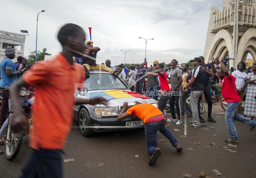 Uncredited People celebrate in the streets in the capital Bamako, Mali Tuesday, Aug. 18, 2020. Mutinous soldiers detained Mali's president and prime minister Tuesday after surrounding a residence and firing into the air in an apparent coup attempt after several months of demonstrations calling for President Ibrahim Boubacar Keita's ouster. (AP Photo)