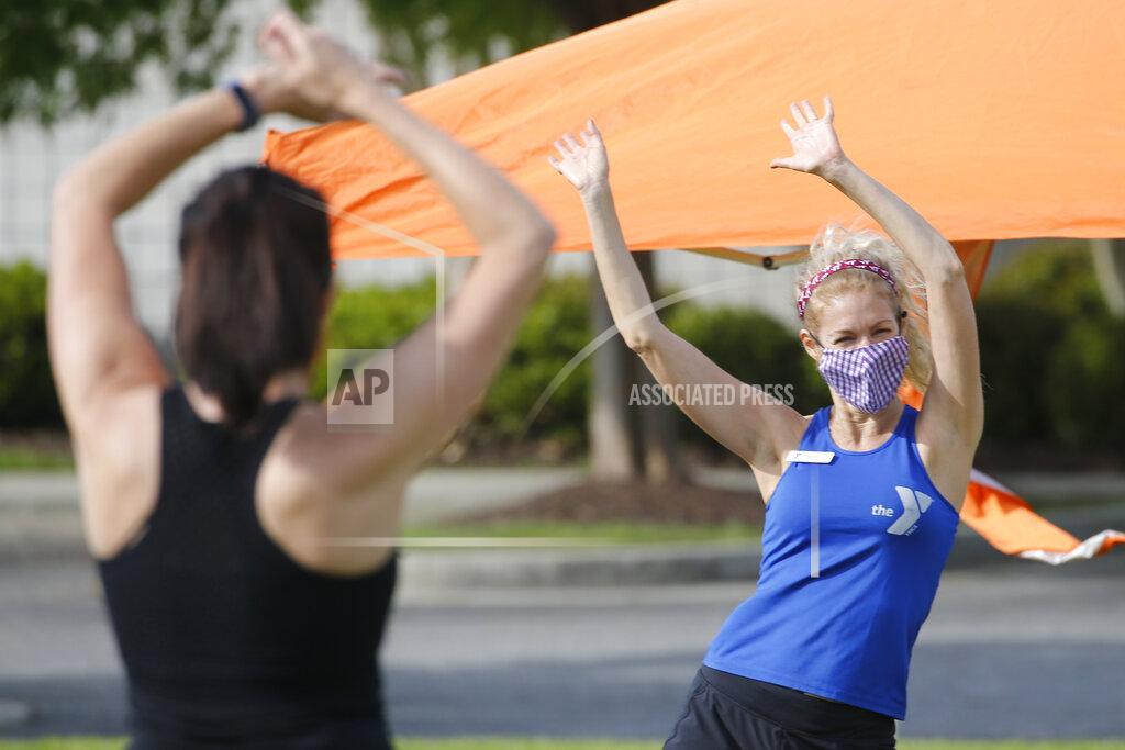 Zumba Gold instructor, Stacey Zebrowski, right, leads a class at the Shady Grove YMCA Friday May 15, 2020, in Glen Allen, Gov. Ralph Northam instituted a phase one reopening of certain portions of the state Friday. (AP Photo/Steve Helber)