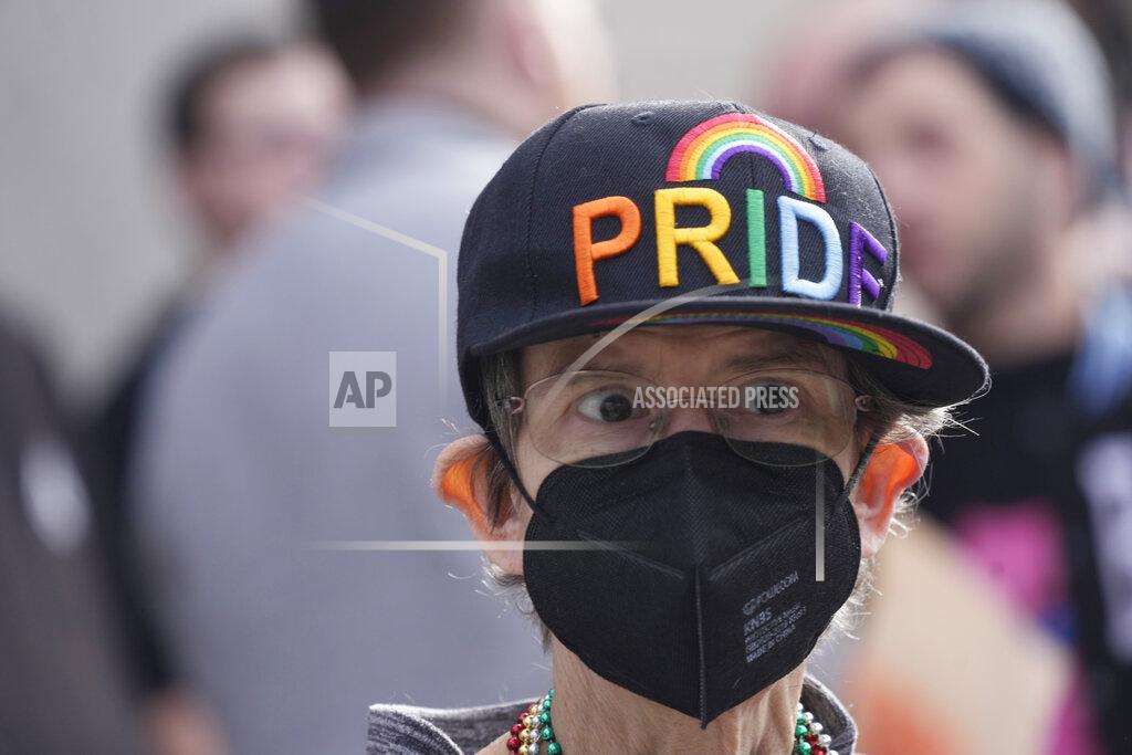 David Zalubowski A supporter of Club Q wears a baseball cap after a 25-foot historic pride flag was displayed on the exterior of city hall to mark the weekend mass shooting at a gay nightclub Wednesday, Nov. 23, 2022, in Colorado Springs, Colo. (AP Photo/David Zalubowski)