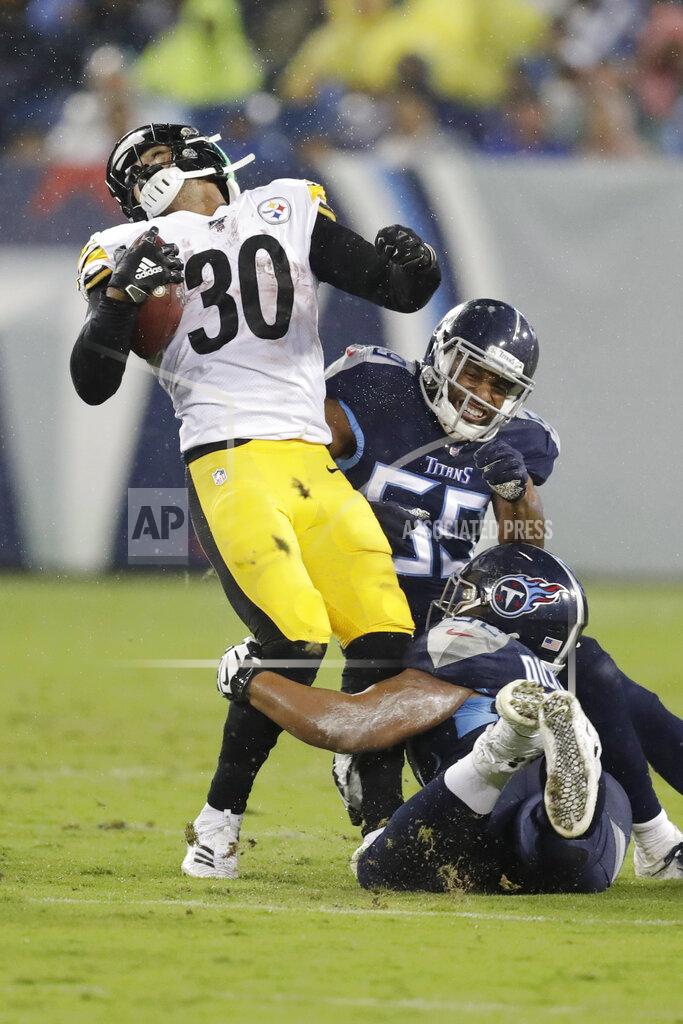 James Kenney Pittsburgh Steelers running back James Conner (30) is stopped by Tennessee Titans inside linebacker Jayon Brown (55) and defensive end Matt Dickerson, bottom, in the first half of a preseason NFL football game Sunday, Aug. 25, 2019, in Nashville, Tenn. (AP Photo/James Kenney)