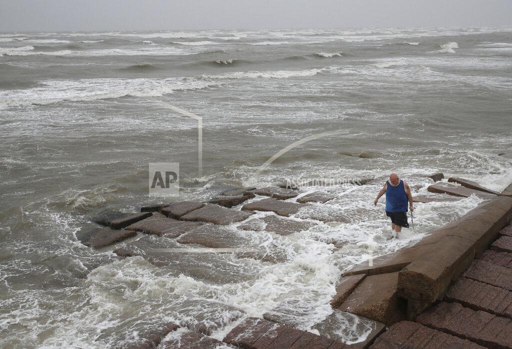 Jon Shapley John Pittman, a nurse who works in emergency medicine, fishes to decompress as Tropical Storm Nicholas heads toward the Texas coast, Monday, Sept. 13, 2021, along the seawall in Galveston, Texas. (Jon Shapley/Houston Chronicle via AP)