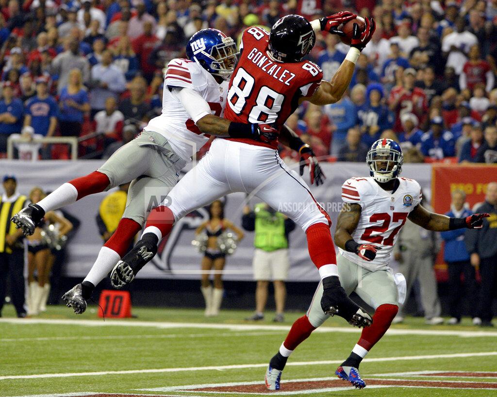 FILE - In this Dec. 16, 2012, file photo, Atlanta Falcons tight end Tony Gonzalez (88) makes a catch in the end zone for a touchdown as New York Giants defensive back Will Hill (31) and strong safety Stevie Brown (27) defend during the first half of an NFL football game, in Atlanta. It was the ability of Gonzalez to make those tough catches, especially on third downs and in the red zone, that helped make him a first-ballot pick who will be inducted into the Pro Football Hall of Fame on Aug. 3, 2019. (AP Photo/Rich Addicks, File)