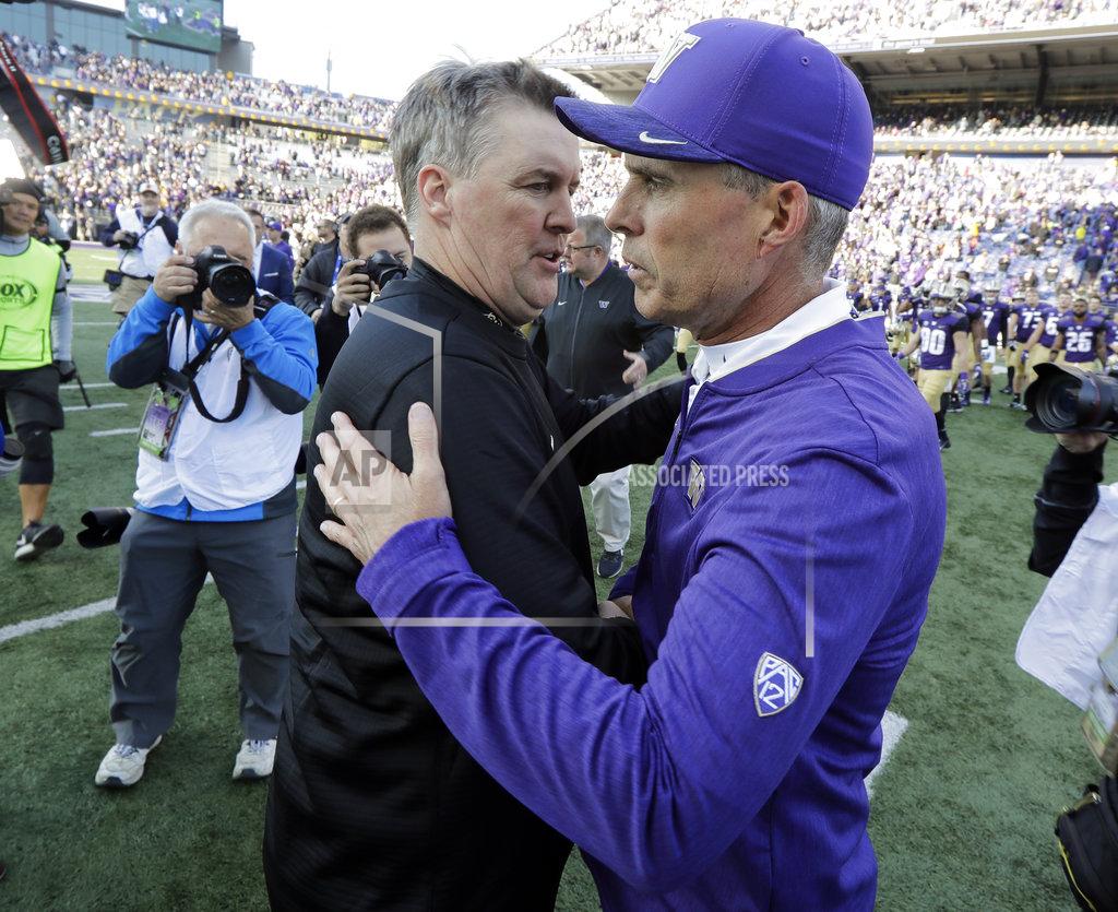 Ted S. Warren Washington head coach Chris Petersen, right, greets Colorado head coach Mike MacIntyre, left, following an NCAA college football game, Saturday, Oct. 20, 2018, in Seattle. Washington won 27-13. (AP Photo/Ted S. Warren)