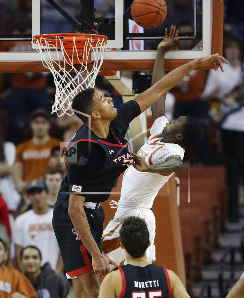 Eric Gay Texas guard Matt Coleman III, right, is blocked by Texas Tech guard Kyler Edwards, left, tduring the first half of an NCAA college basketball game, Saturday, Feb. 8, 2020, in Austin, Texas. (AP Photo/Eric Gay)