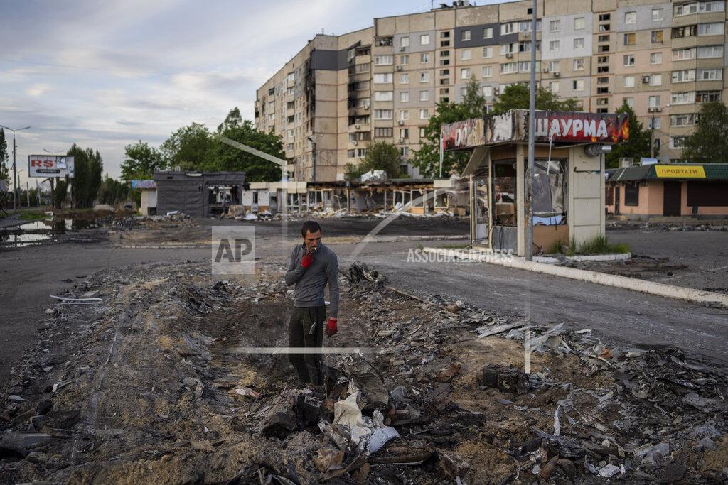 Bernat Armangue A man searches for metal scraps in a shelled neighbourhood in Kharkiv, eastern Ukraine, Thursday, May 19, 2022. (AP Photo/Bernat Armangue)