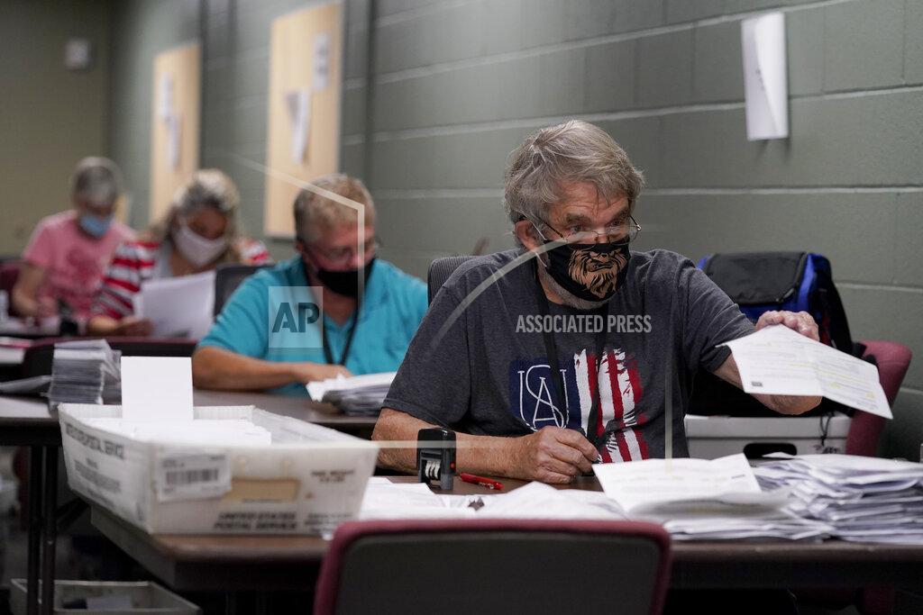 Election workers open and sort mail-in ballot requests Tuesday, Sept. 22, 2020, at the Johnson County election office in Olathe, Kan. The office has processed more than 100,000 mail-in ballot requests so far as more people than normal are expected to vote by mail due to concerns about the coronavirus. (AP Photo/Charlie Riedel)