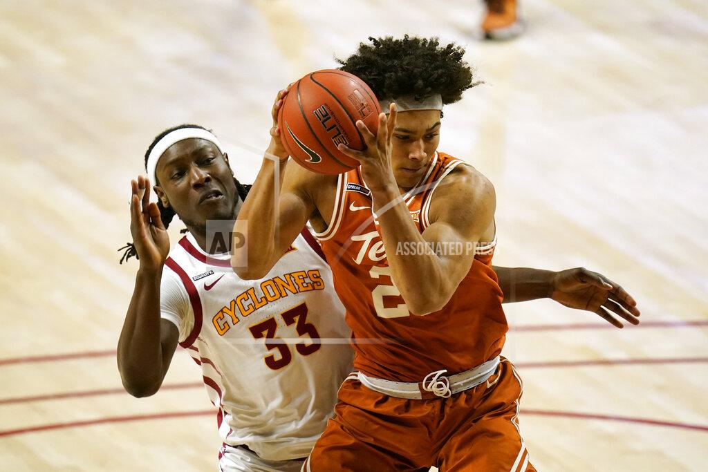 Charlie Neibergall Texas forward Jericho Sims is fouled by Iowa State forward Solomon Young (33) during the first half of an NCAA college basketball game, Tuesday, March 2, 2021, in Ames, Iowa. (AP Photo/Charlie Neibergall)