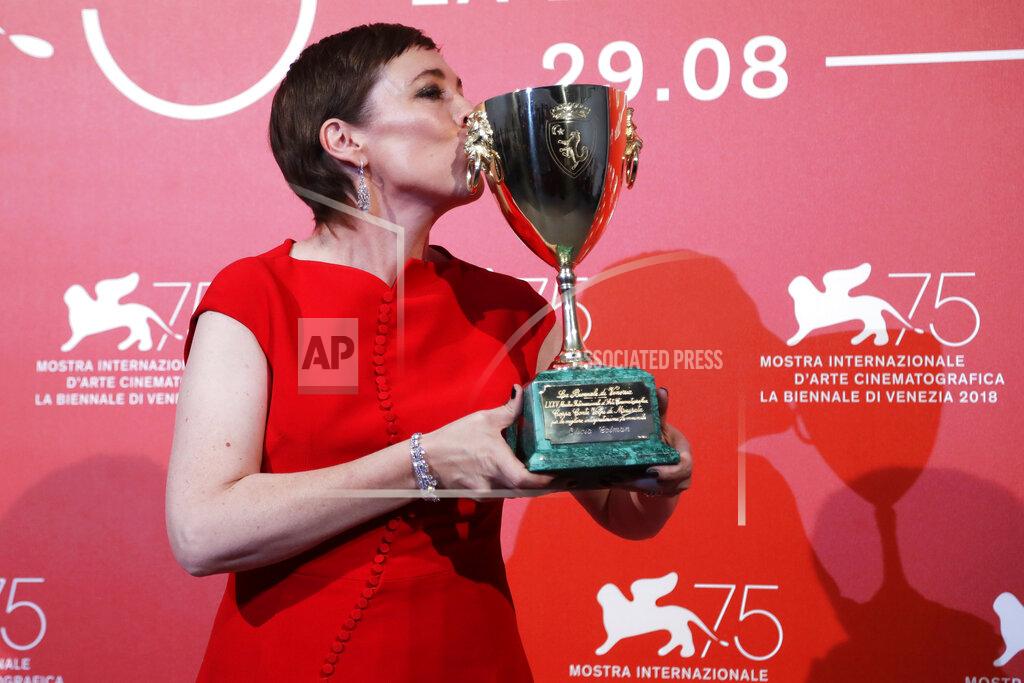 Kirsty Wigglesworth File - Actress Olivia Colman kisses the Coppa Volpi Best Actress award for 'The Favourite' at the Venice Film Festival. The 77th Venice Film Festival will kick off on Wednesday, Sept. 2, 2020, but this year's edition will be unlike any others. Coronavirus restrictions will mean fewer Hollywood stars, no crowds interacting with actors and other virus safeguards will be deployed. (AP Photo/Kirsty Wigglesworth, File)
