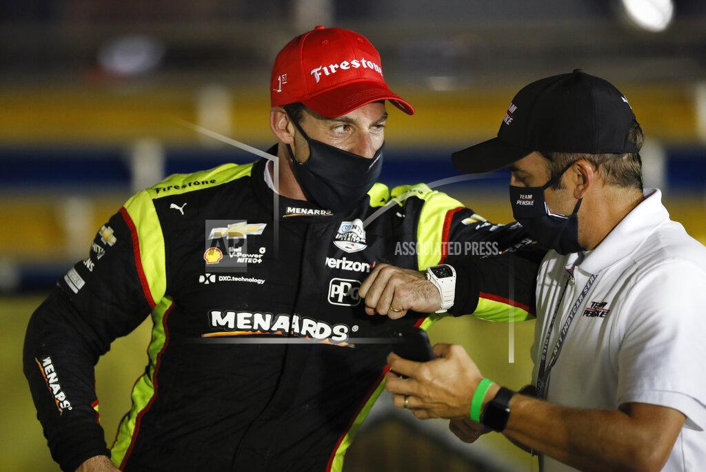 Charlie Neibergall Simon Pagenaud, left, of France, celebrates in Victory Lane after winning an IndyCar Series auto race Friday, July 17, 2020, at Iowa Speedway in Newton, Iowa. (AP Photo/Charlie Neibergall)