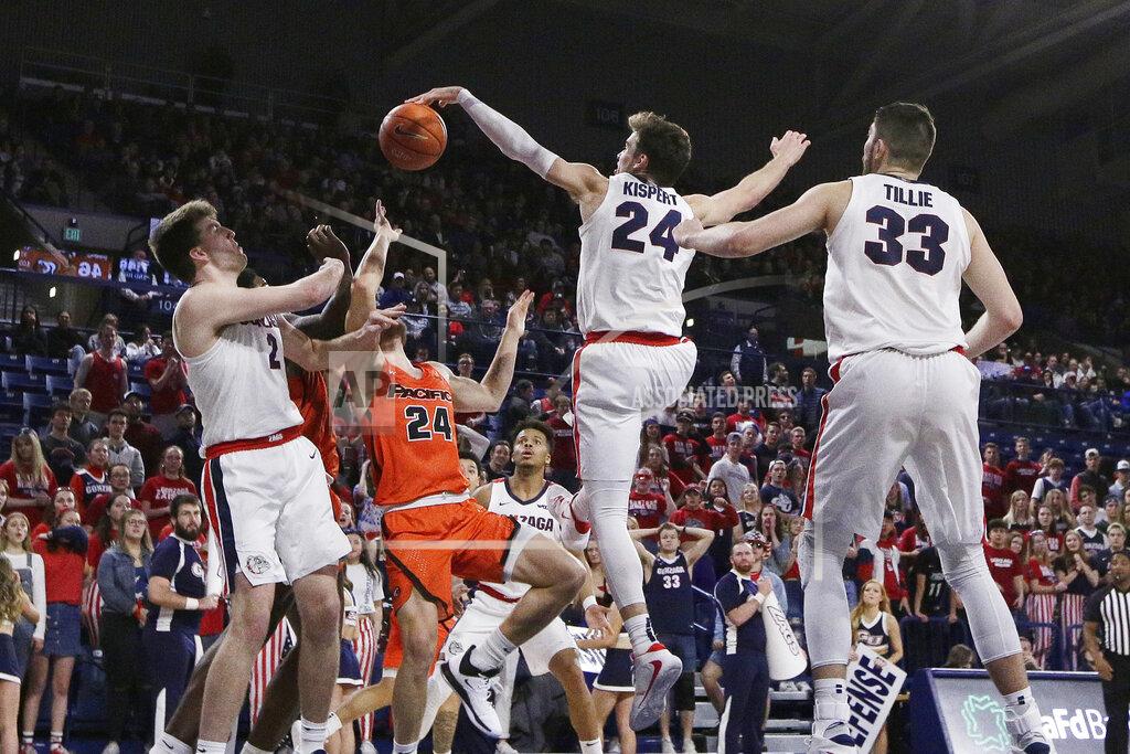 Young Kwak Gonzaga forward Corey Kispert, second from the right, blocks a shot by Pacific guard Broc Finstuen, second from the left, in front of teammates Drew Timme, left, and Killian Tillie during the second half of an NCAA college basketball game in Spokane, Wash., Saturday, Jan. 25, 2020. Gonzaga won 92-59. (AP Photo/Young Kwak)
