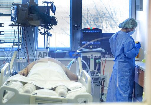 FILE - Medical staff attend to a patient at the COVID-19 ICU unit of the hospital in Bratislava, Slovakia, Tuesday, Nov. 23, 2021. Slovakia recorded another new record in coronavirus infections as the government was discussing a national lockdown to tame the surge on Wednesday. (Martin Baumann/TASR via AP, File)