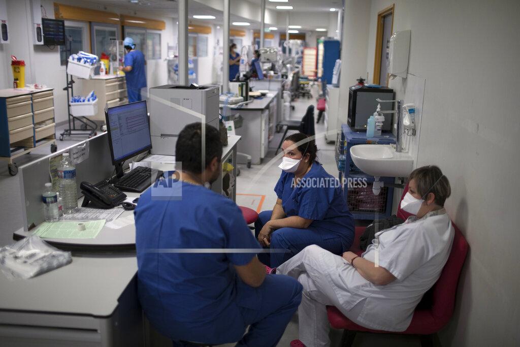 Daniel Cole Nurses gather in the COVID-19 ICU at the La Timone hospital in Marseille, southern France, Tuesday Feb. 2, 2021. COVID patients occupy 88% of the Marseille region's intensive care beds, and virus pressure on French hospitals is steadily rising in recent weeks despite curfews and other restrictions. (AP Photo/Daniel Cole)