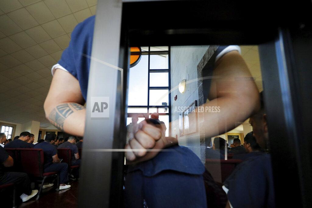 Gerald Herbert FILE — Immigration detainees listen to a Pentecostal preacher who is a fellow detainee in a packed chapel inside the Winn Correctional Center, in Winnfield, La., in this Thursday, Sept. 26, 2019 file photo. The number of detainees nationwide has more than doubled since the end of February 2021, to nearly 27,000, according to recent data from U.S. Immigration and Customs Enforcement. (AP Photo/Gerald Herbert, File)