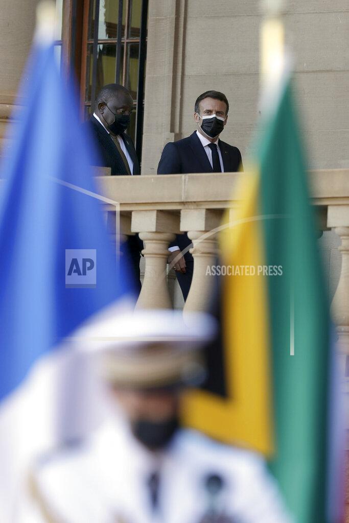 Themba Hadebe South African President Cyril Ramaphosa, left, and his French counterpart Emmanuel Macron arrive a press conference at the government's Union Building, in Pretoria, South Africa, Friday, May 28, 2021. Macron is on a two-day official visit to the country. (AP Photo/Themba Hadebe, Pool)
