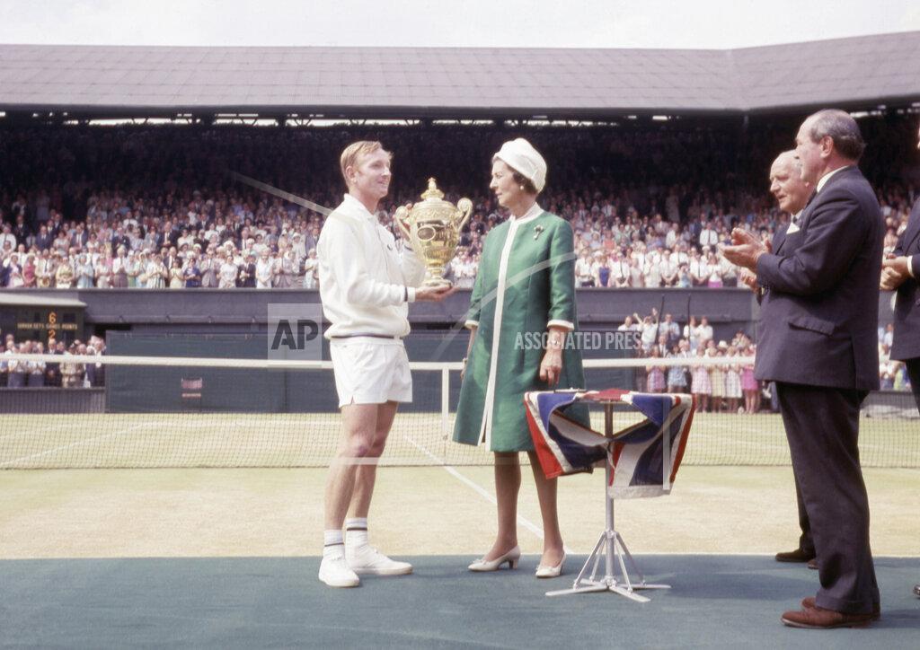 Robert Dear FILE - In this July 1968 file photo, Princess Marina presents Australia's Rod Laver with the trophy for winning the men's tennis final at Wimbledon, against Tony Roche. (AP Photo/Robert Dear, File)