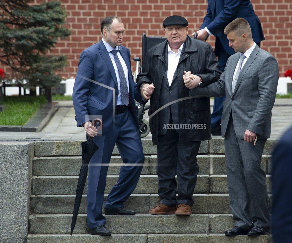 Alexander Zemlianichenko FILE In this file photo taken on Thursday, May 9, 2019, Former Soviet leader Mikhail Gorbachev, center, is helped by his assistants as he arrives to attend the Victory Day military parade to celebrate 74 years since the victory in WWII in Red Square in Moscow, Russia. Former Soviet leader Mikhail Gorbachev turned 90 on Tuesday, March 2, 2021 receiving greetings from the Kremlin and global leaders while Russians remained divided over his legacy. (AP Photo/Alexander Zemlianichenko, File)