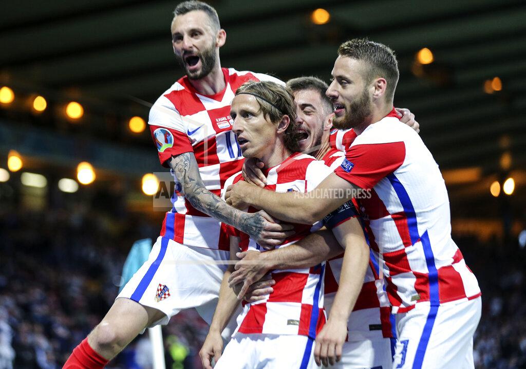 Robert Perry Croatia's Luka Modric is celebrated after scoring his side's second goal during the Euro 2020 soccer championship group D match between Croatia and Scotland at the Hampden Park Stadium in Glasgow, Tuesday, June 22, 2021.(Robert Perry/Pool via AP))