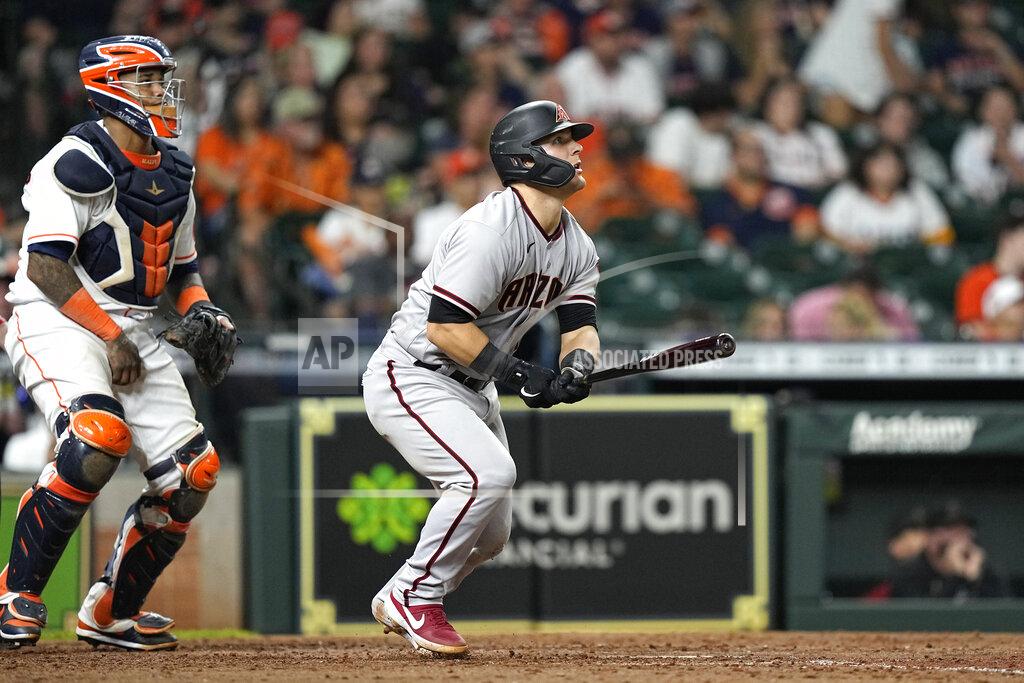 David J. Phillip Arizona Diamondbacks' Daulton Varsho, right, hits a two-run home run as Houston Astros catcher Martin Maldonado looks on during the 10th inning of a baseball game Saturday, Sept. 18, 2021, in Houston. (AP Photo/David J. Phillip)