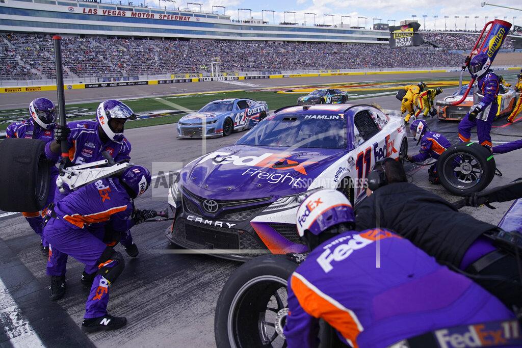John Locher Denny Hamlin (11) makes a pit stop during a NASCAR Cup Series auto race Sunday, March 6, 2022, in Las Vegas. (AP Photo/John Locher)