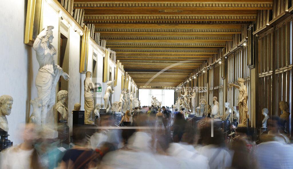 Luca Bruno FILE - In this Aug. 6, 2019 file photo, visitors walk through corridors of the Uffizi Gallery Museum, in Florence, Italy. On Monday, April 20, 2020, Italy was completing its sixth week of nationwide lockdown with at least two more weeks to go, as part of government efforts to contain the spread of COVID-19. Director of the Uffizi Gallery, Eike Schmidt expects a boom in visitors after pandemic restrictions end, judging by the experience after previous emergencies closed down one of the world’s most popular museums. (AP Photo/Luca Bruno)