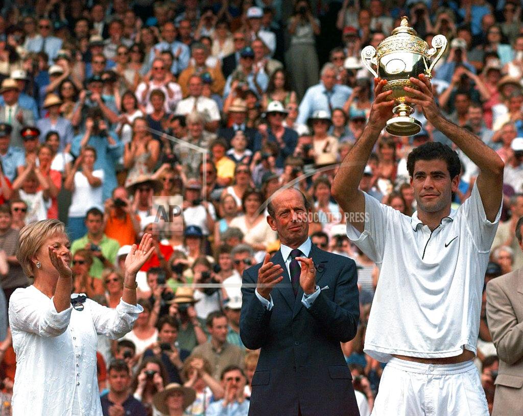 Elise Amendola FILE - In this July 6, 1977, file photo, the Duke and Duchess of Kent applaud as Pete Sampras of the United States holds aloft the men's singles trophy after beating Cedric Pioline of France, 6-4, 6-2, 6-4, on Wimbledon's Centre Court. (AP Photo/Elise Amendola, File)