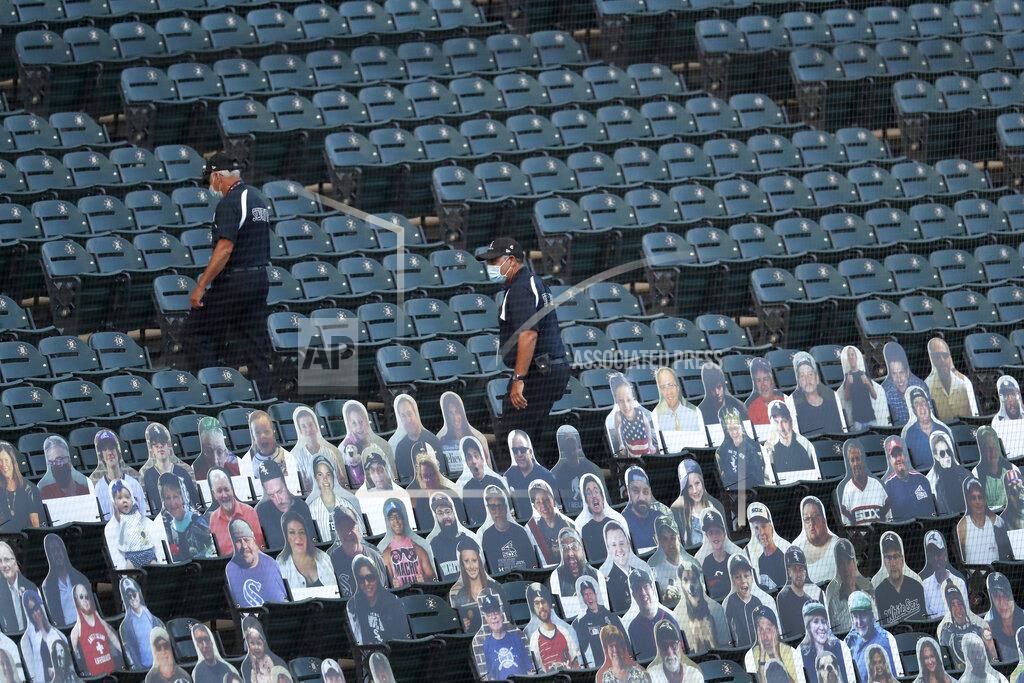Charles Rex Arbogast Security personnel walk through the seats and past cardboard cutouts of fane before an opening days baseball game between the Chicago White Sox and the Minnesota Twins, Friday, July 24, 2020, in Chicago. (AP Photo/Charles Rex Arbogast)