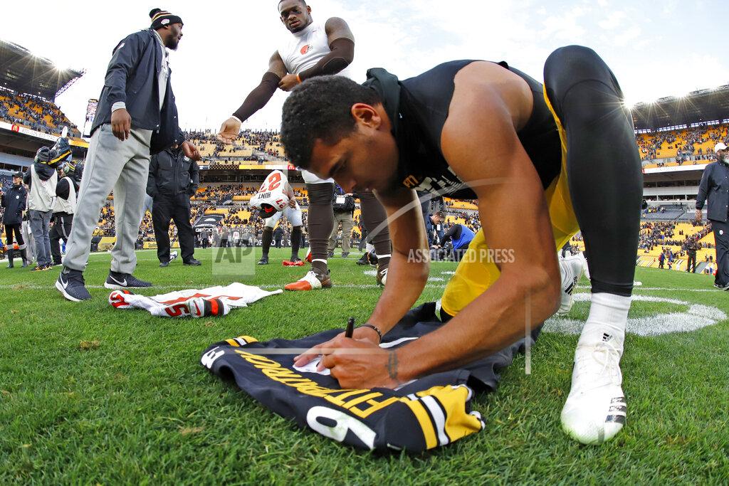 Gene J. Puskar In this Dec. 1, 2019 file photo Pittsburgh Steelers free safety Minkah Fitzpatrick, right, signs his game jersey to swap with Cleveland Browns linebacker Tae Davis (51) following a Steelers win in an NFL football game in Pittsburgh. Fitzpatrick's arrival in Pittsburgh last fall turned a pretty good defense into one of the NFL's best. His goal for an encore after earning All-Pro status? Helping Pittsburgh return to the playoffs. (AP Photo/Gene J. Puskar, File)